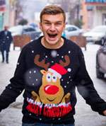 Man wearing a sweater with a picture of a reindeer and the words, "Merry Christmas"